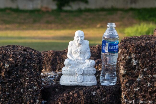 monk statue and water bottle as offering in south chapter of gopura
