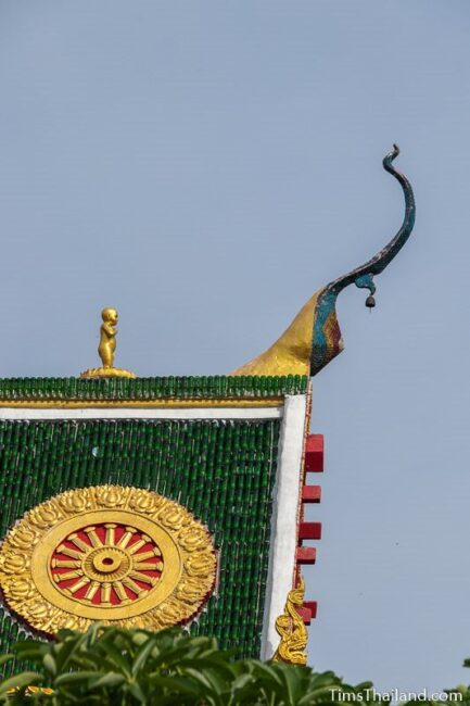 Baby Buddha statue on roof peak of ubusot