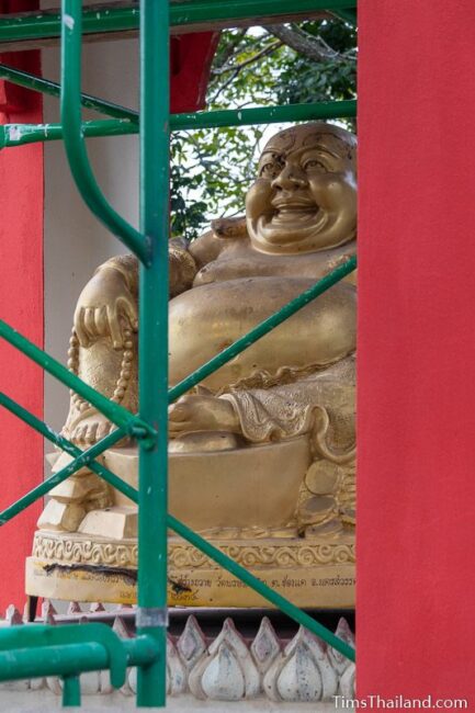 Budai statue with scaffolding in front of it