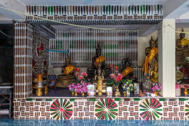 Buddha shrine with bottle art around it