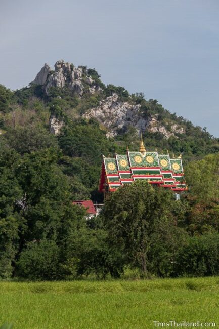 bottle ubosot and peak of mountain seen from a distance