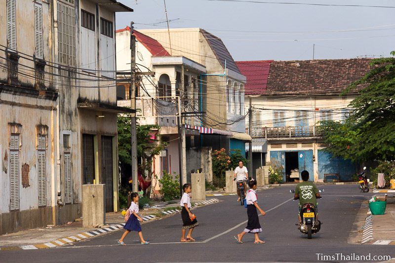 students in uniform walking across the street