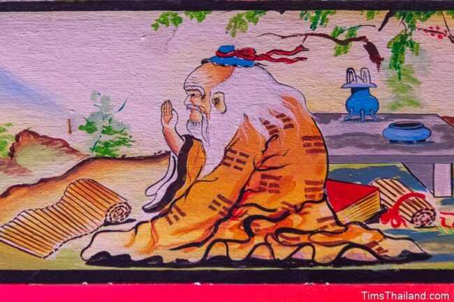 painting of person with scrolls