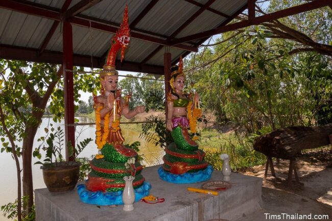 two statues of naga with human bodies