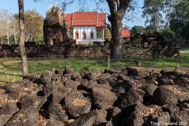 pile of stones with temple ruin behind