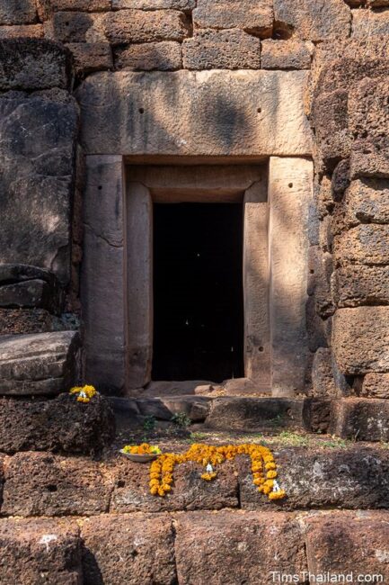 front door of prang with flower offerings on steps