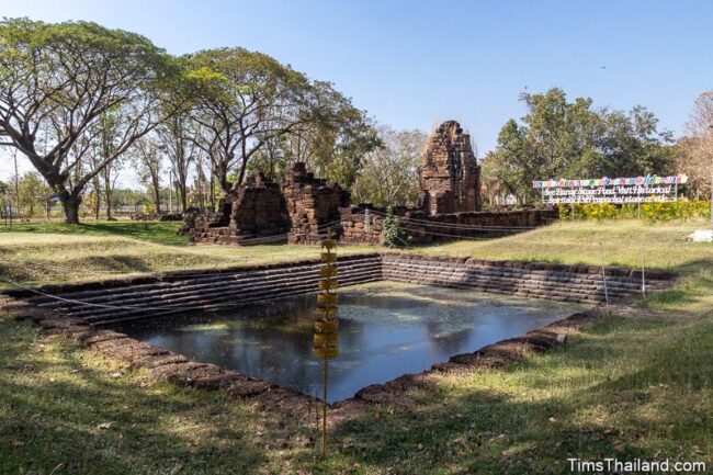 view of the pond in front and temple ruin in back