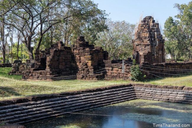 view of the pond in front and temple ruin in back