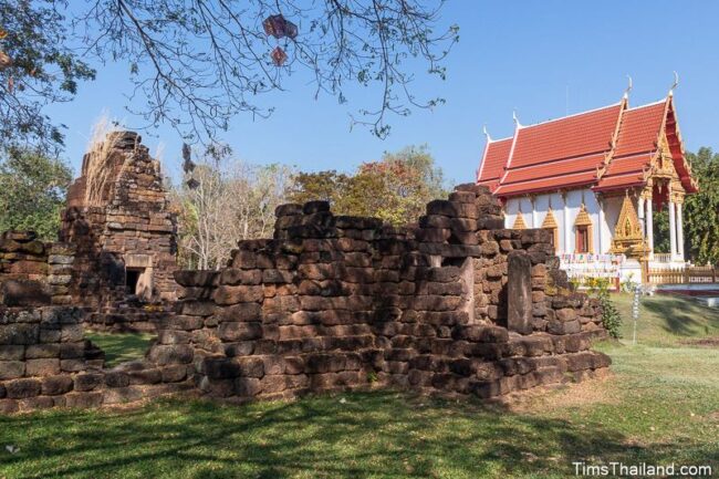 view of the ruin with a modern temple building in back