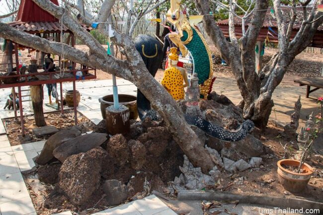 pile of stones with ruesi, naga, and cobra