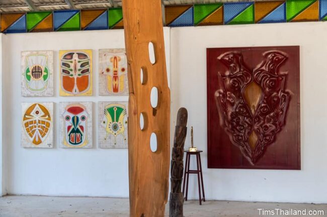 paintings and woodcarvings in a gallery