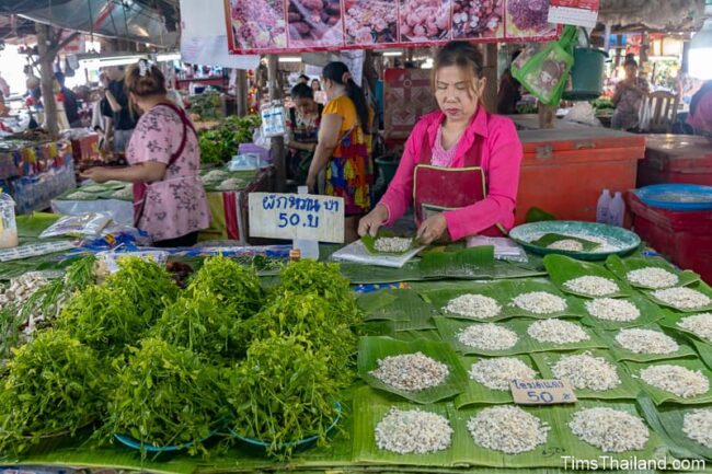 vendor with red ant eggs in market