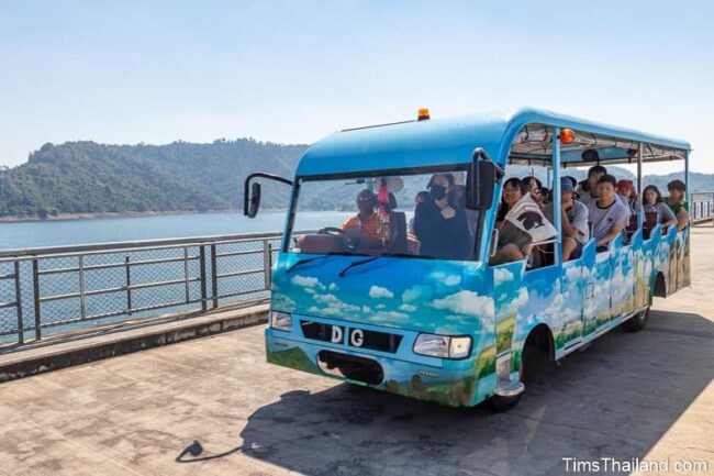 shuttle bus atop a dam