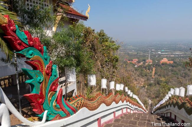 staircase lined by a long naga leading down mountain