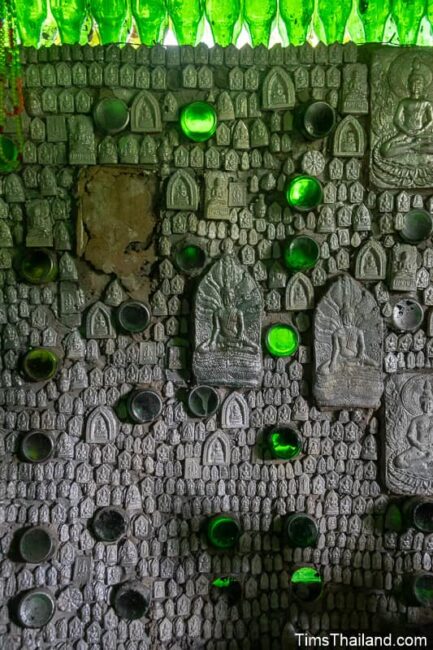 amulets and bottles on interior wall