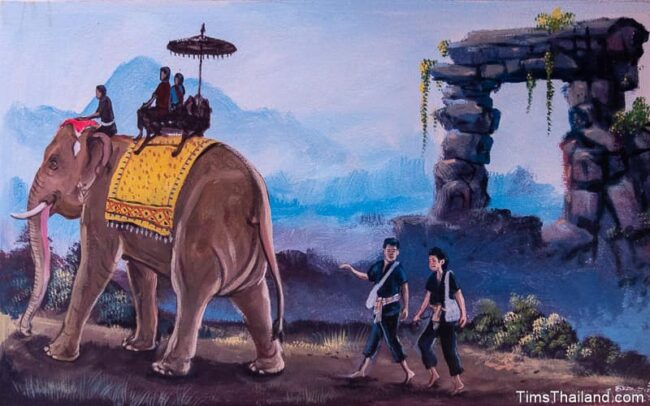 people riding an elephant and others walking behind it