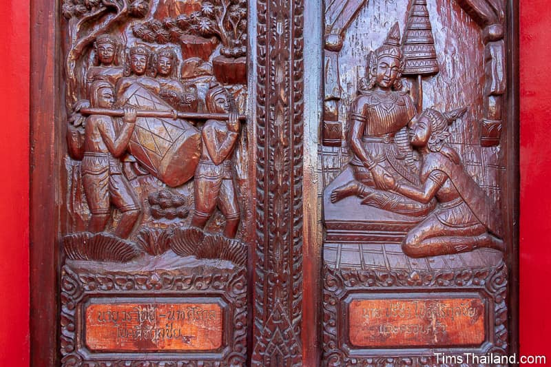 wood-carved shutters of men carrying a large drum and two women talking