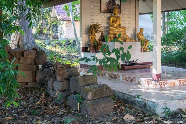 pile of sandstone blocks with Buddhas in background