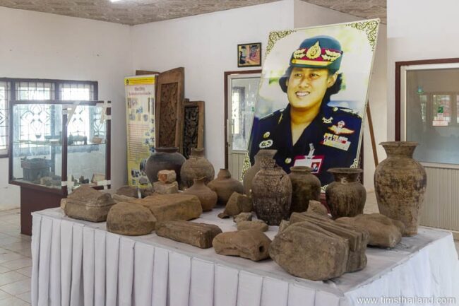 sandstone carving and pottery on table in museum