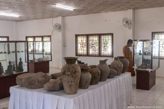 sandstone carving and pottery on table in museum