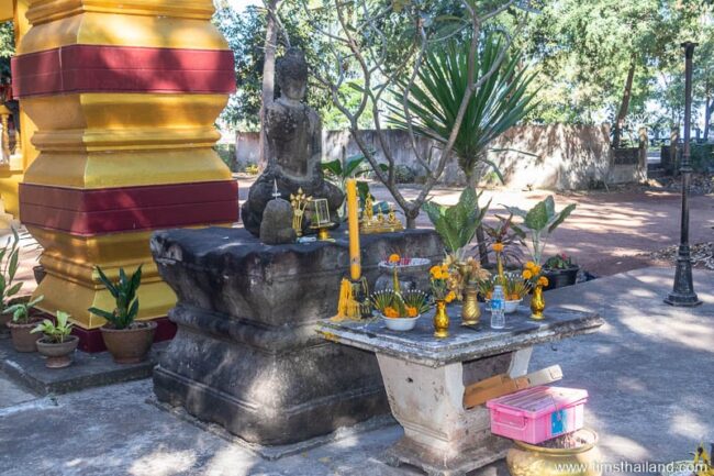 Khmer pedestal with ancient Buddha on top of it