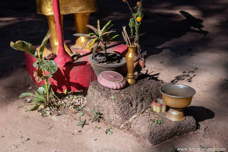 two laterite blocks at the base of a Phra Siwali statue