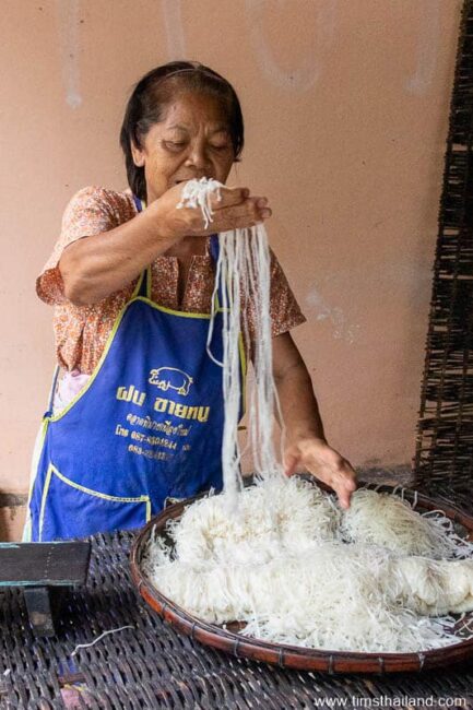 woman preparing to bundle phimai noodles