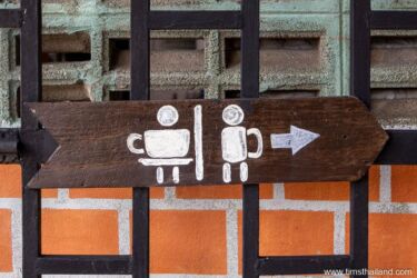 bathroom sign incorporating coffee cups