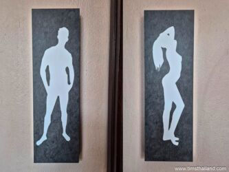 thai bathroom sign with naked people